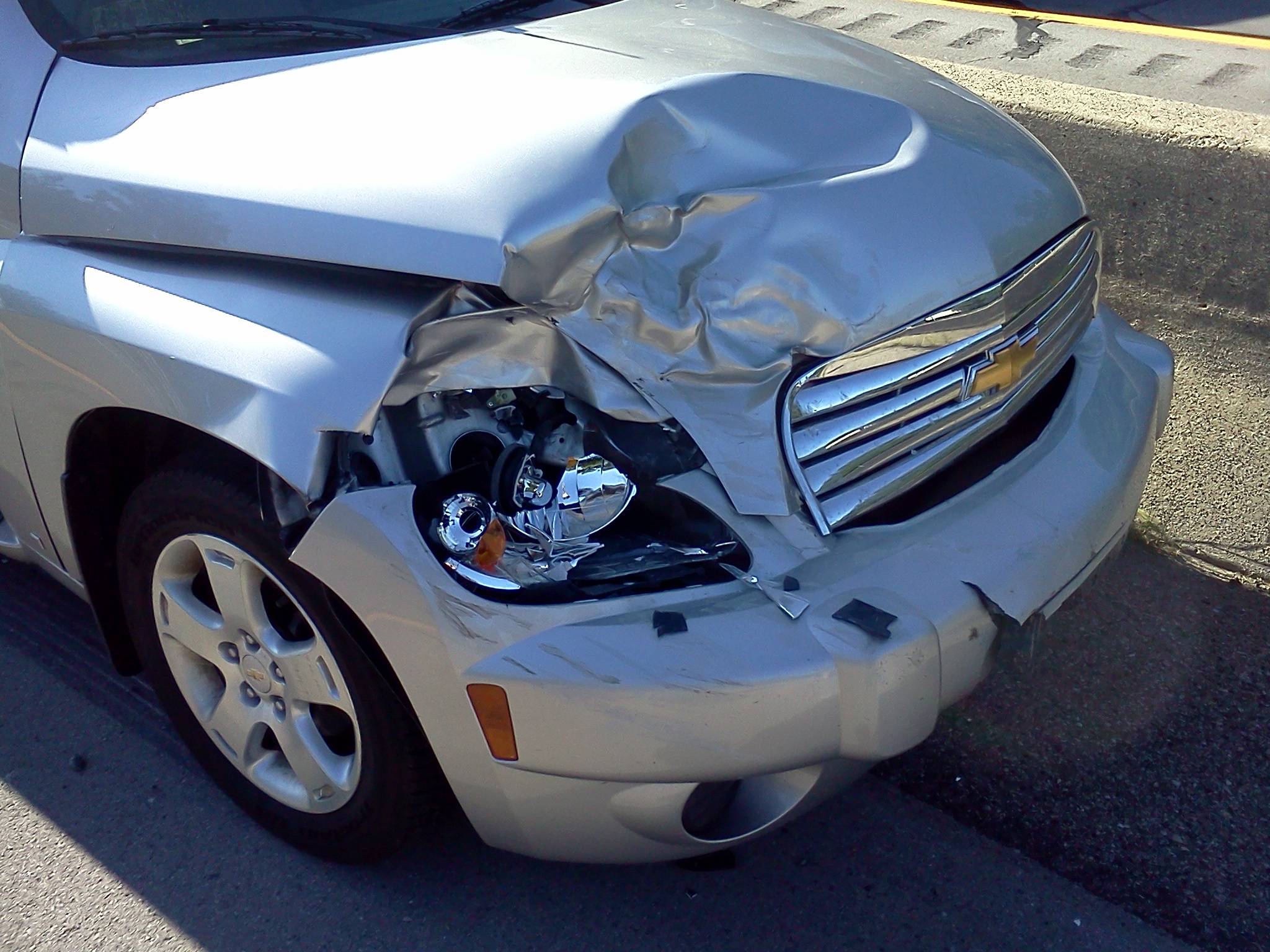 A car with front-end crash damage, analysed by Claimly with the damaged region outlined