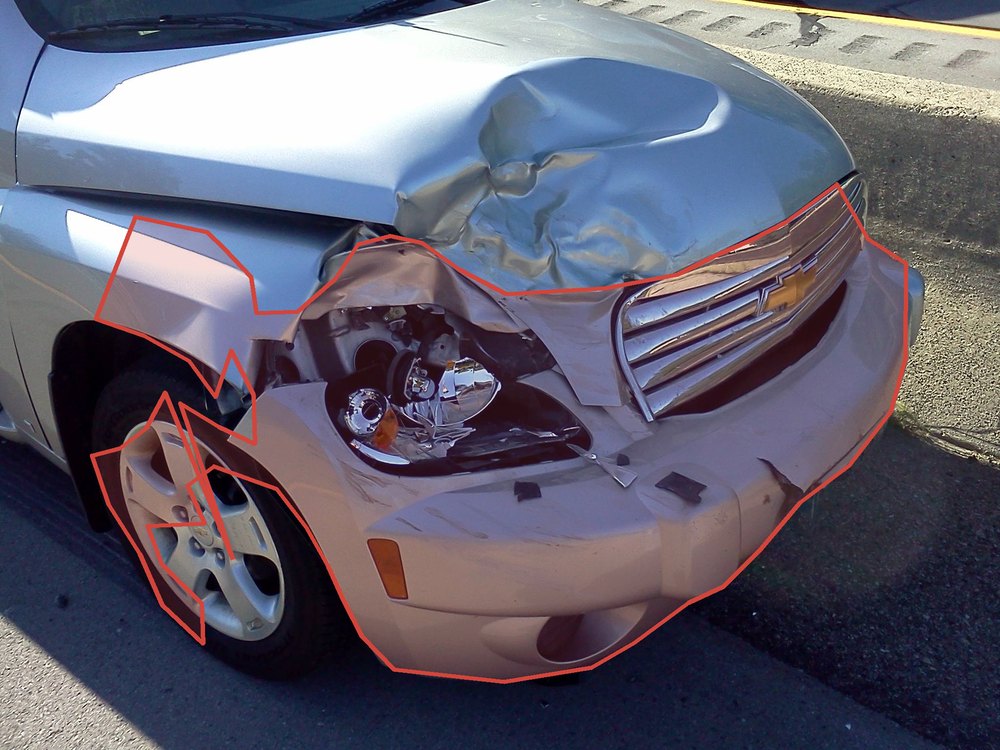 A car with front-end crash damage, the damaged region highlighted by Claimly